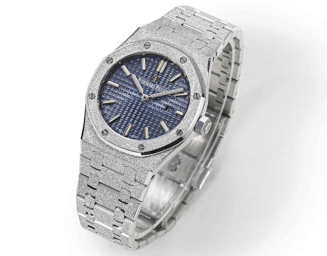 Silver watch with blue dial and metal link bracelet, angled view