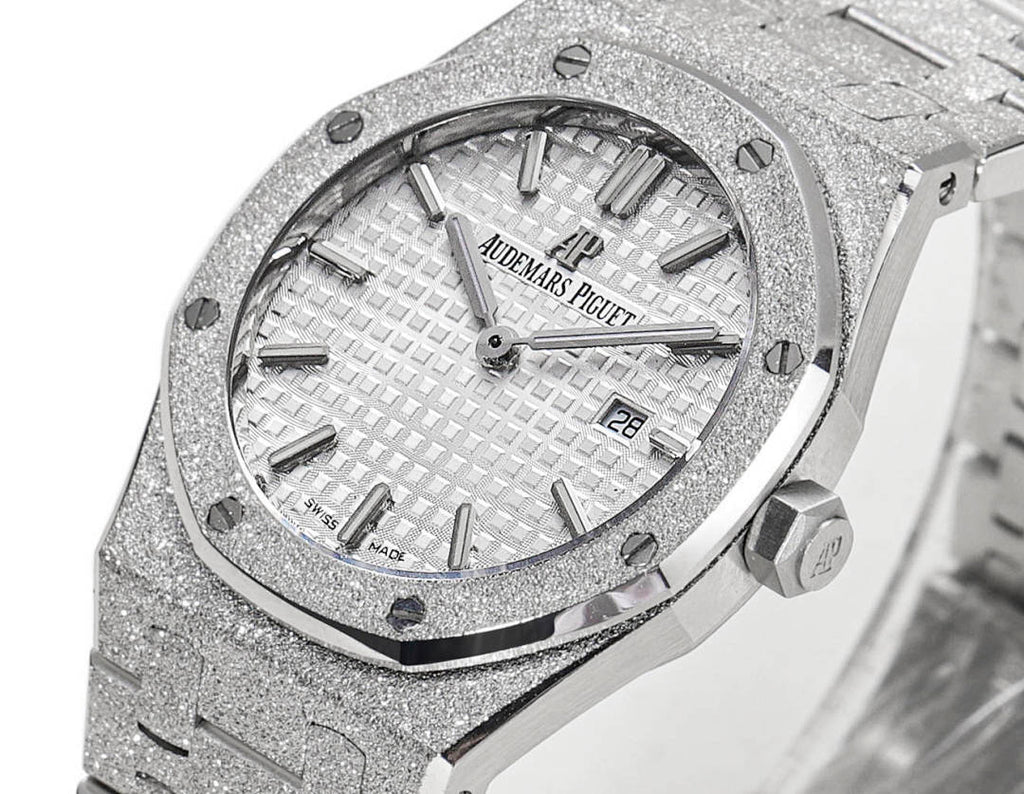 Audemars Piguet watch front with date window at 28, textured dial, steel bracelet