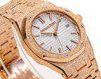 Audemars Piguet watch close-up of rose-gold bezel and white textured dial