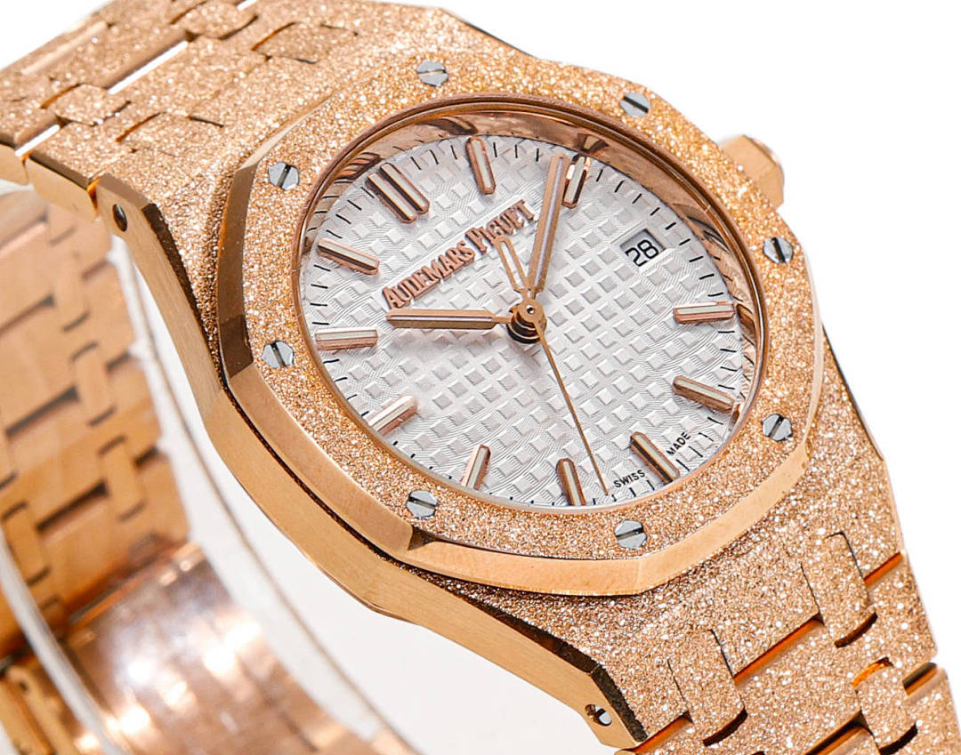 Audemars Piguet watch close-up of rose-gold bezel and white textured dial