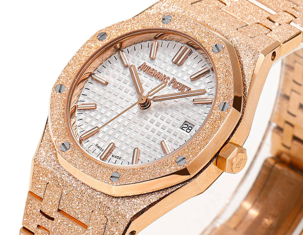 Audemars Piguet watch close-up of white dial, rose-gold markers and date window