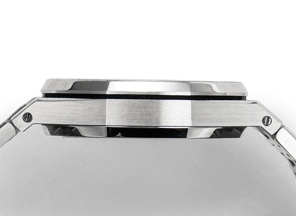 Steel watch case close-up showing bezel edge and black-lined ring detail.
