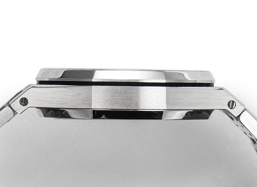 Steel watch case close-up showing bezel edge and black-lined ring detail.