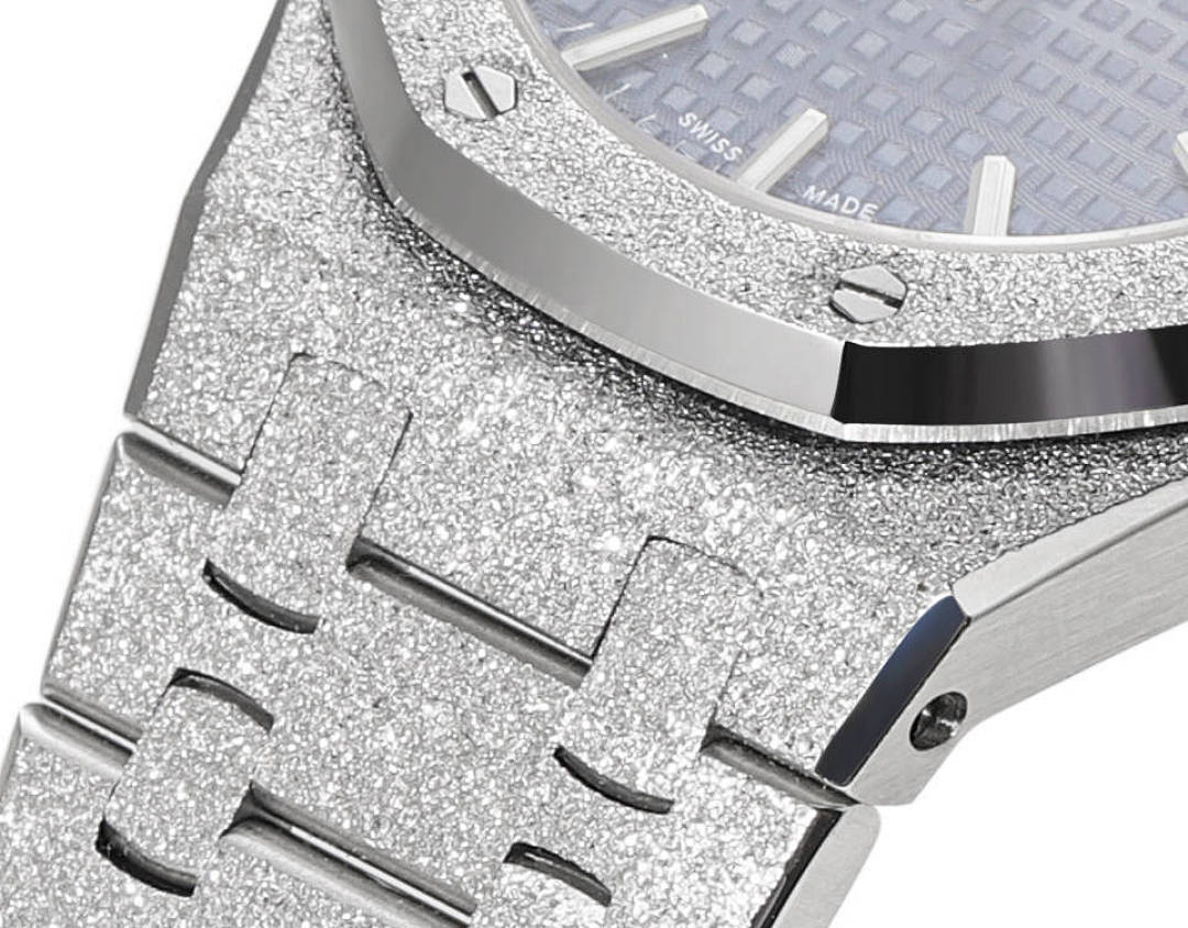 Glitter-textured silver bezel and case with blue dial edge visible near the crown.