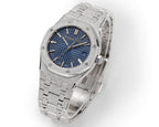 Blue dial steel wristwatch with textured link bracelet and crown on the right side.