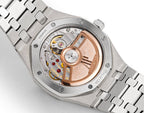 Audemars Piguet watch with open caseback showing mechanical movement and copper-toned parts