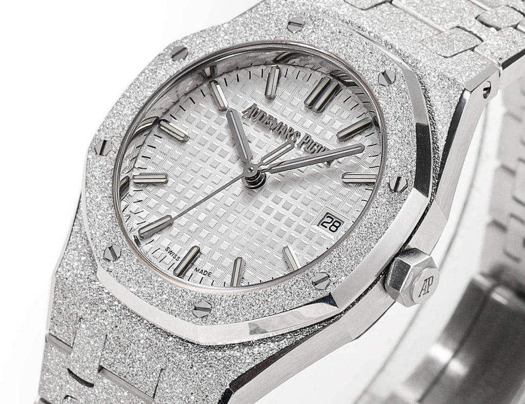 Audemars Piguet watch face with textured silver dial, baton hands, and date at 28