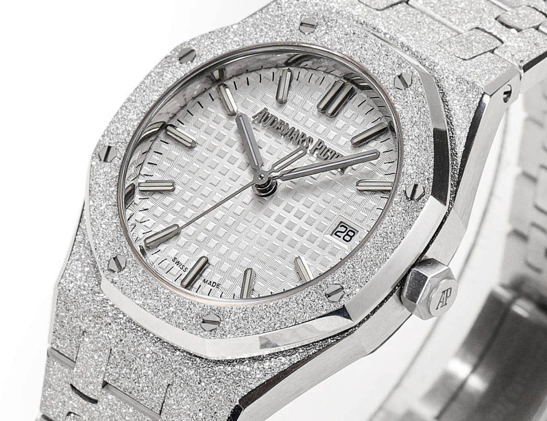 Audemars Piguet watch face with textured silver dial, baton hands, and date at 28