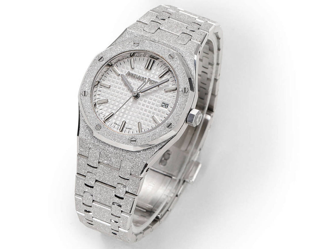 Audemars Piguet watch showing white dial, textured bezel, and silver bracelet