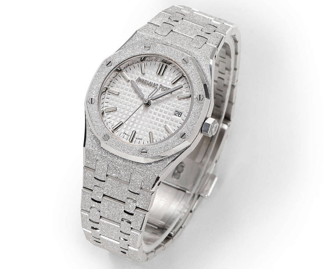 Audemars Piguet watch showing white dial, textured bezel, and silver bracelet