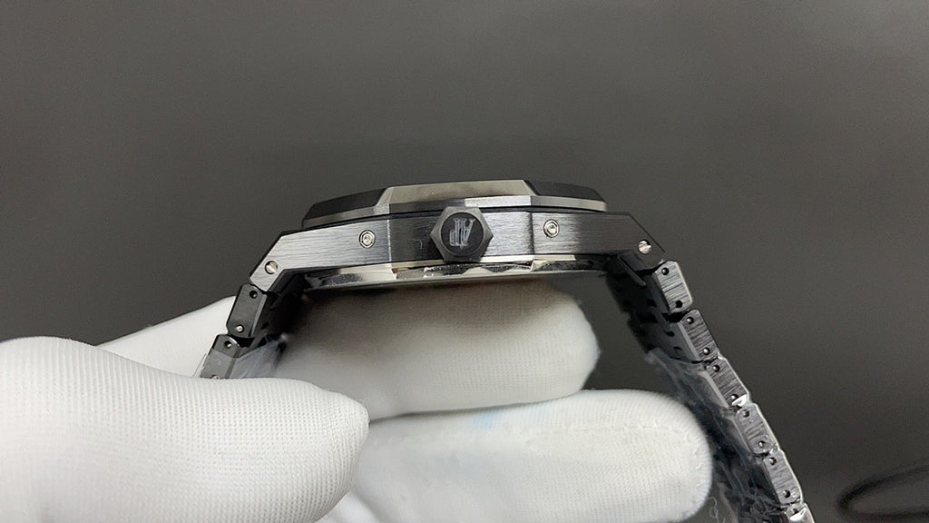 Audemars Piguet watch with crown and pushers on dark bezel, steel bracelet