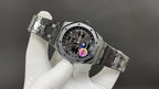Audemars Piguet watch with open clasp and black dial, steel link bracelet