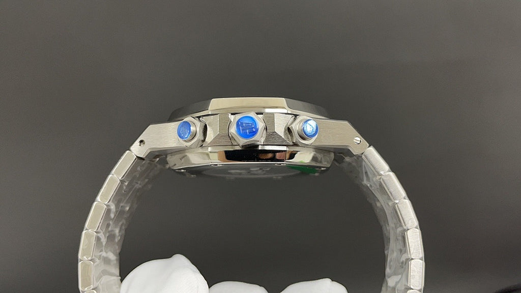 Audemars Piguet watch with polished steel bezel, blue accents, and crown