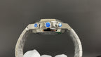 Audemars Piguet watch with polished steel bezel, blue accents, and crown