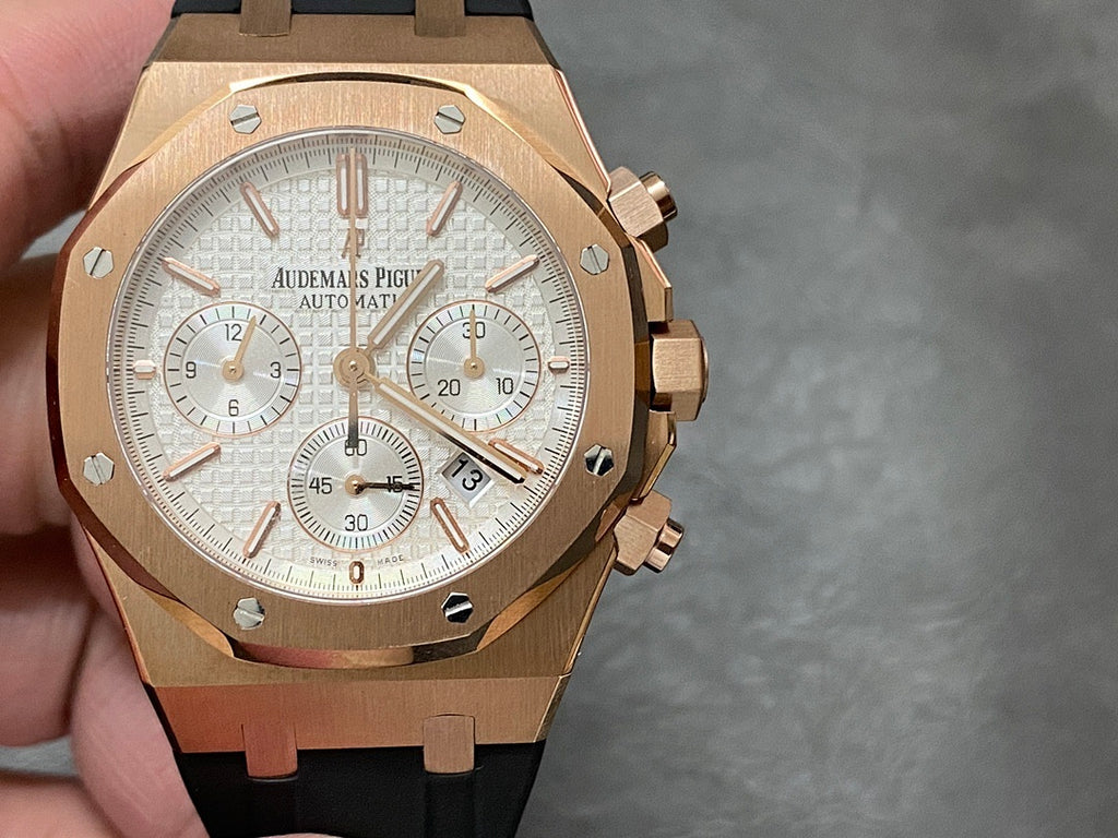 Rose gold chronograph watch with silver dial and black rubber strap, three subdials