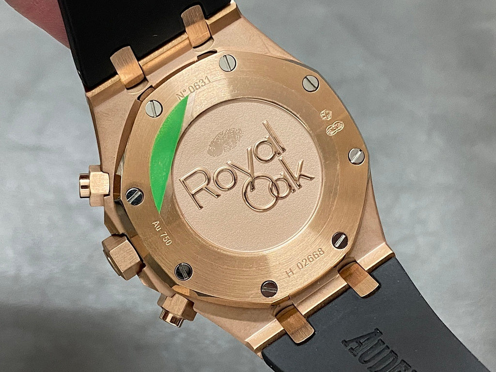 Rose gold watch caseback with Royal Oak engraving and black rubber strap