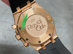 Rose gold watch caseback with Royal Oak engraving and black rubber strap