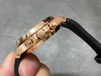 Rose gold watch case with crown detail and black rubber strap