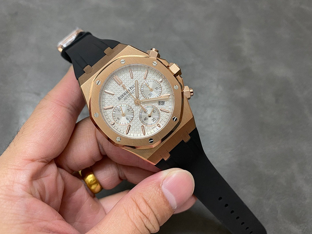 Rose gold chronograph watch with silver dial and black rubber strap, full front view