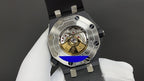 Audemars Piguet watch caseback with exposed mechanical movement on black strap