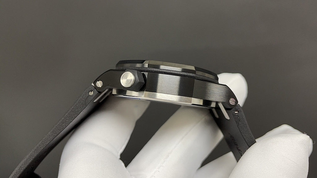 Audemars Piguet watch side view with silver crown and pushers on black strap