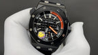 Audemars Piguet watch with black dial, orange bezel ring, and chronograph subdials