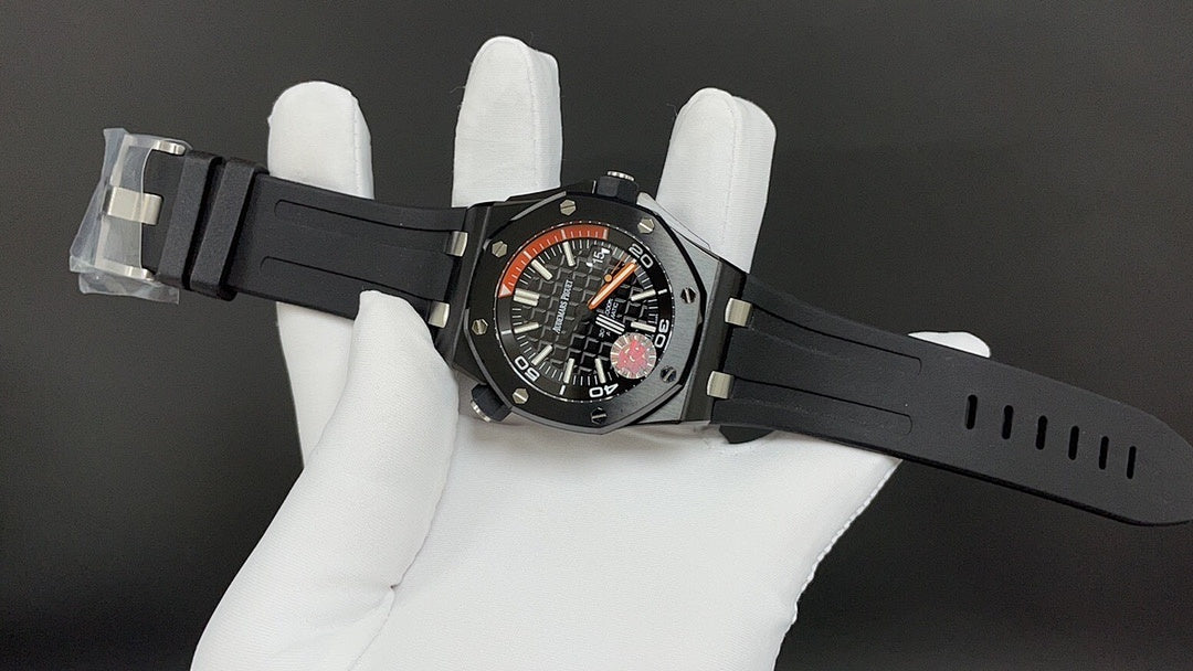 Audemars Piguet watch on black rubber strap with orange dial and visible hands