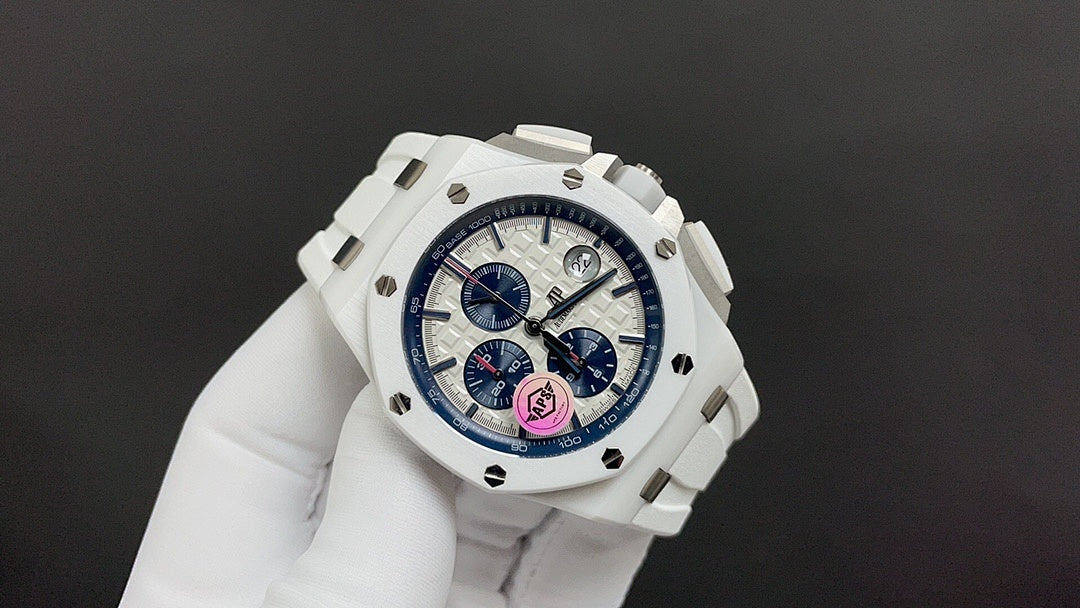 Audemars Piguet watch angled view, white case, blue dial, colored central emblem.
