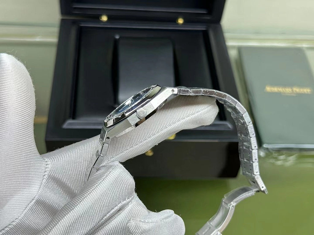 Audemars Piguet watch clasp and bracelet link detail in gloved hand
