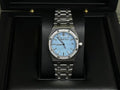 Audemars Piguet watch: blue dial, gem-set bezel, stainless steel bracelet
