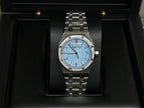 Audemars Piguet watch: blue dial, gem-set bezel, stainless steel bracelet