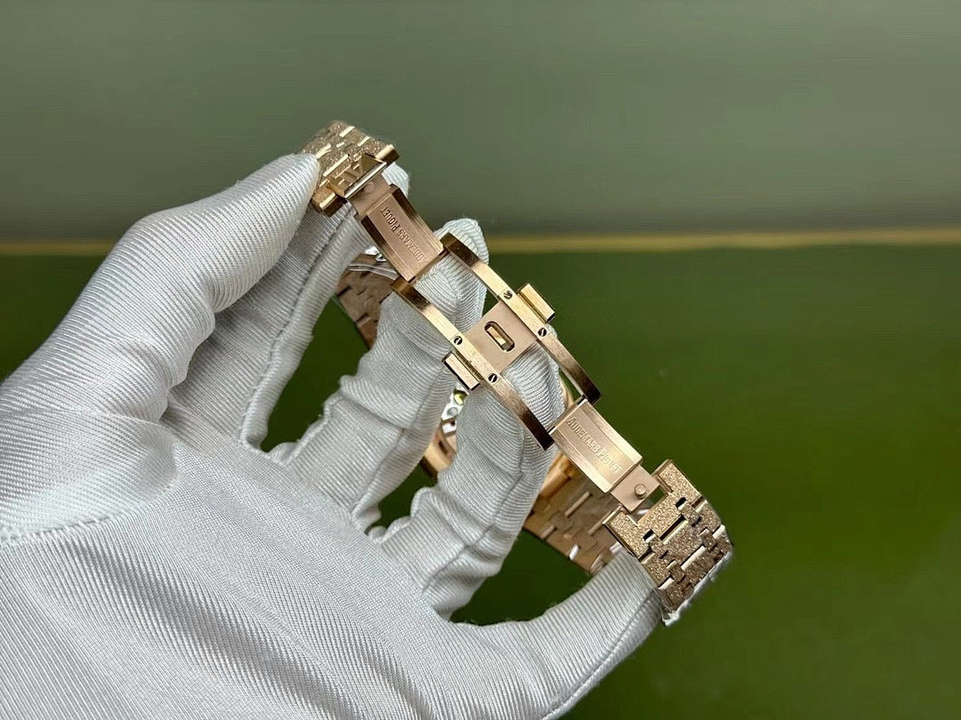Gold-tone Audemars Piguet watch on bracelet with clasp shown from the side