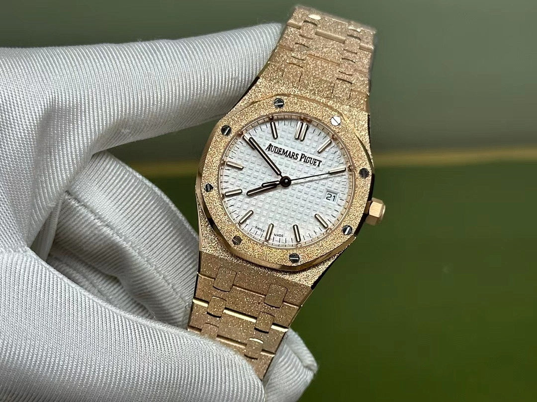 Gold-tone Audemars Piguet wristwatch with white dial and black hands, date window visible