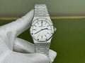 Audemars Piguet Royal Oak watch with silver dial and steel bracelet, held in white glove