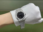 Audemars Piguet stainless steel wristwatch on wrist, black dial and integrated metal bracelet