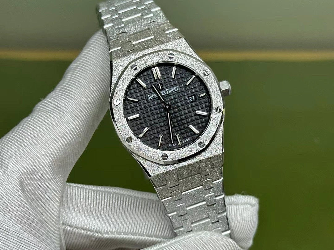 Audemars Piguet stainless steel wristwatch, black dial with date at 27 and metal bracelet
