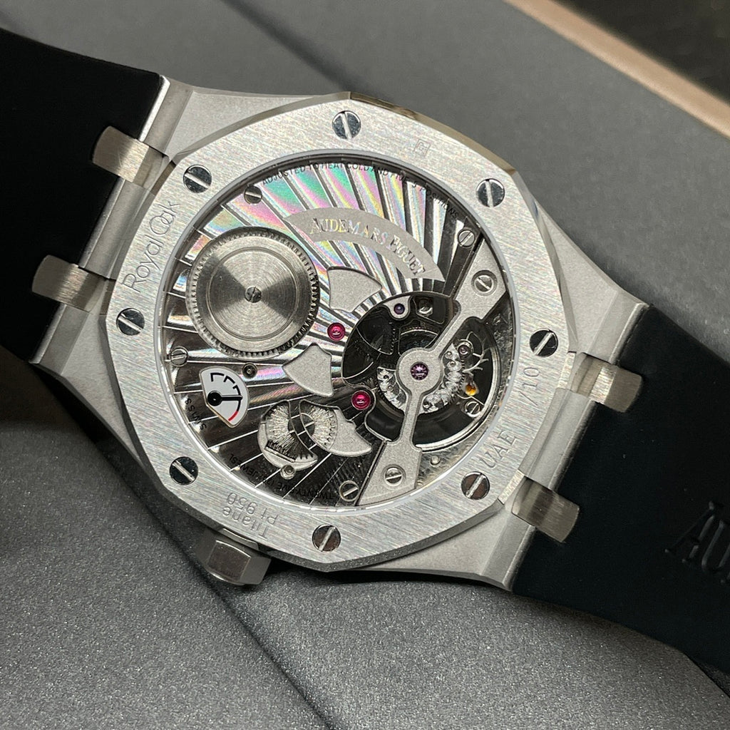 Audemars Piguet watch with exposed skeleton dial, metallic case, and black rubber strap