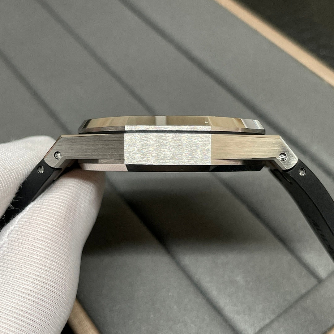 Audemars Piguet watch case view with black rubber strap and brushed metal top surface