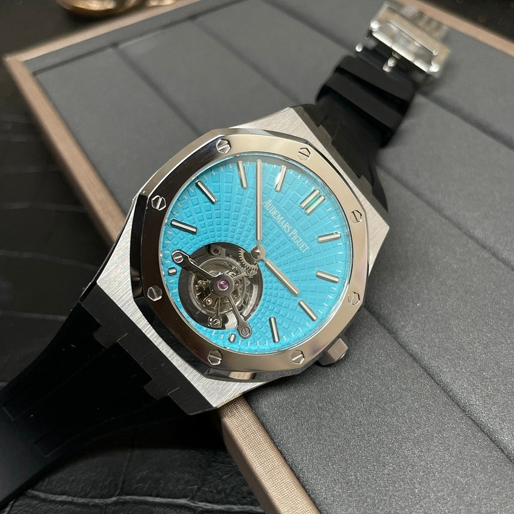 Audemars Piguet watch with blue dial, metal case, and black rubber strap