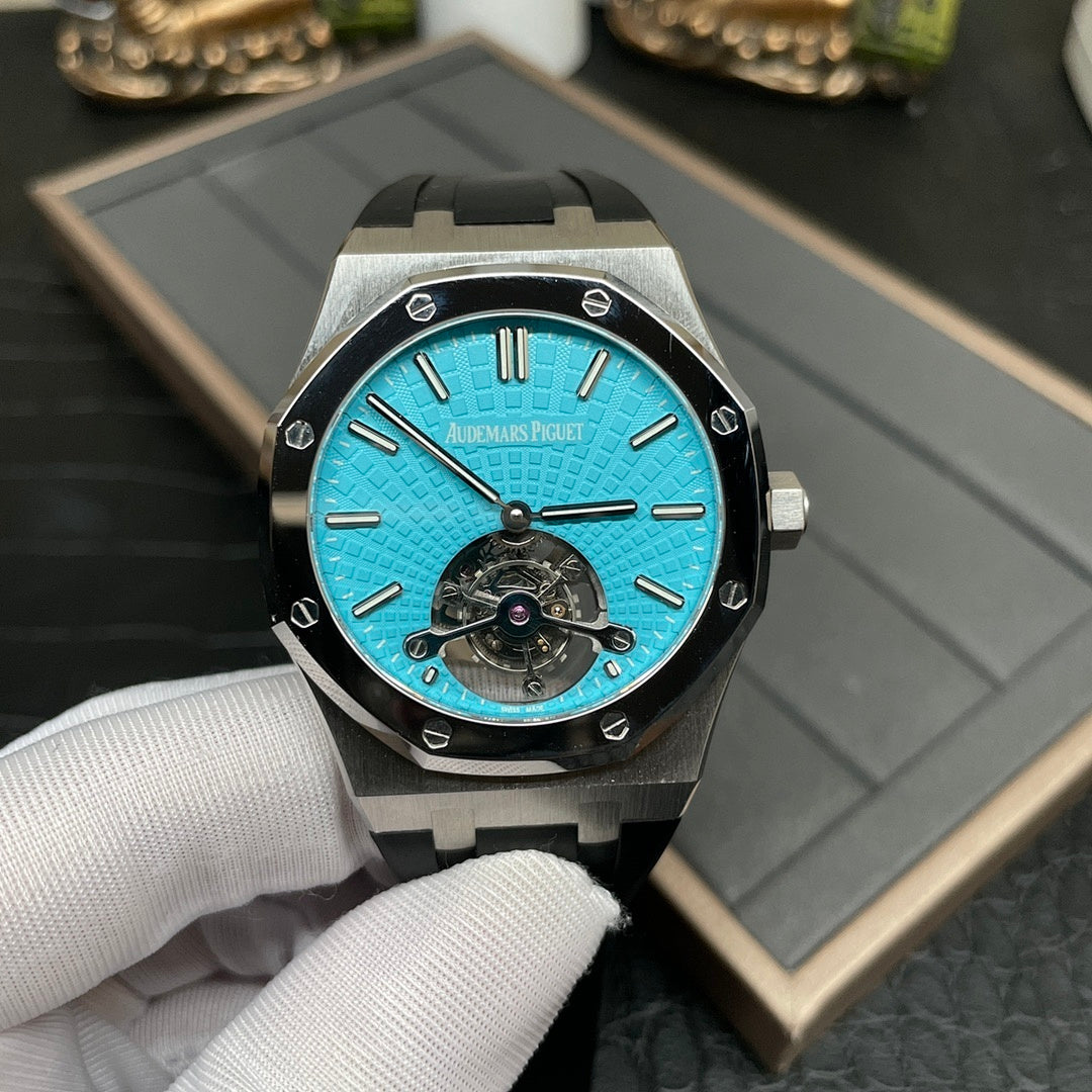 Audemars Piguet watch with cyan-blue dial, metal bezel, and black rubber strap