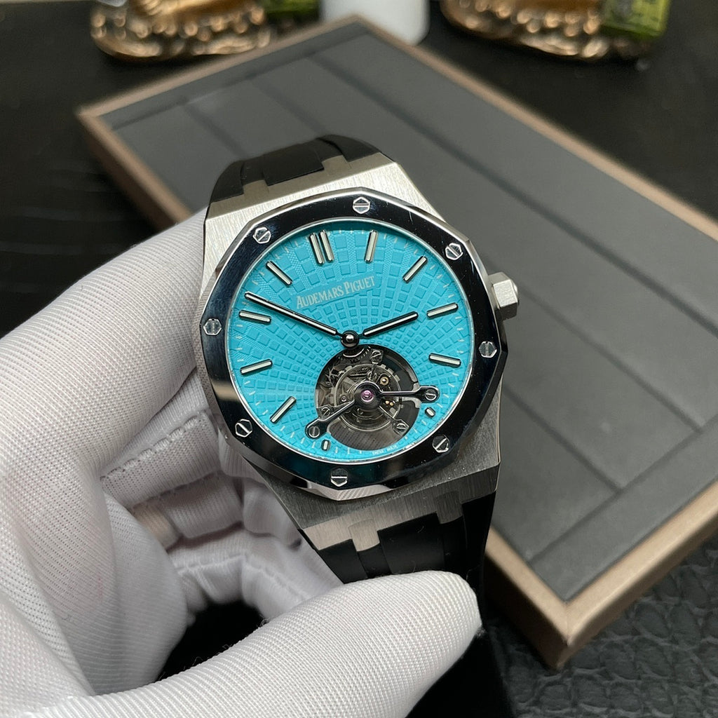 Audemars Piguet watch with blue dial, visible mechanical movement, and black rubber strap