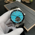 Audemars Piguet watch with blue dial, visible mechanical movement, and black rubber strap