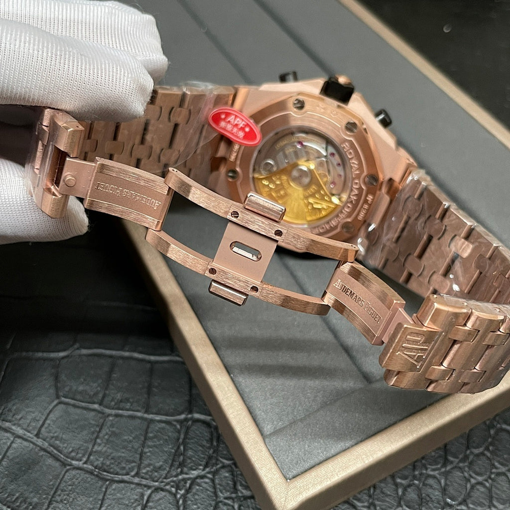 Rose-gold watch caseback with visible mechanical movement and red inspection tag