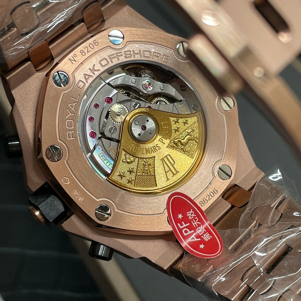 Rose-gold skeleton watch caseback with gold-toned movement and engraved back plate