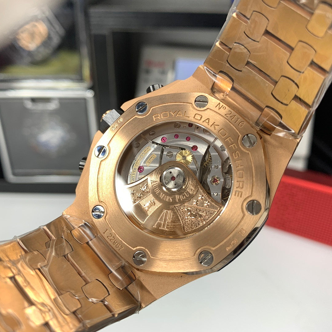 Audemars Piguet Royal Oak watch with open caseback showing gold-toned mechanical movement