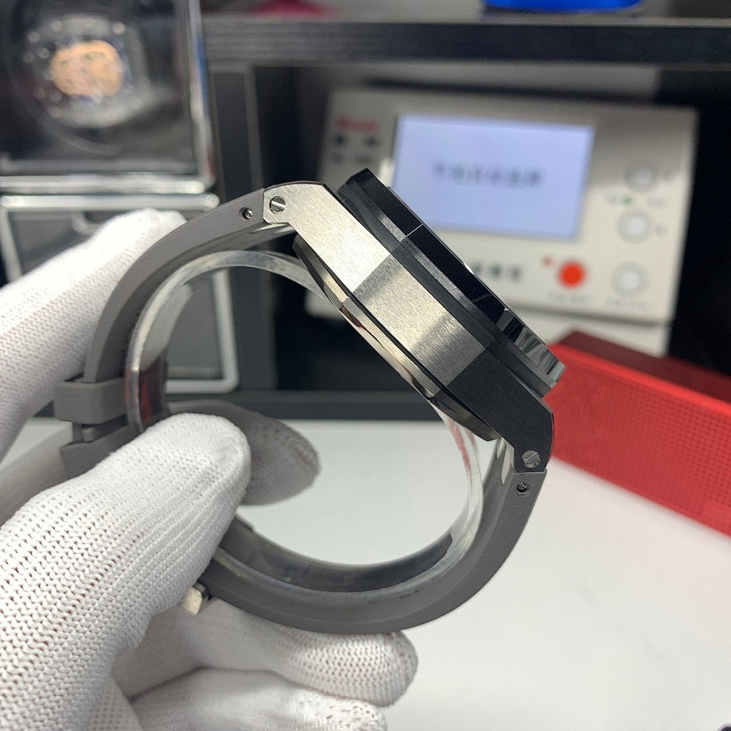 Audemars Piguet watch side with crown and brushed metal case on black strap
