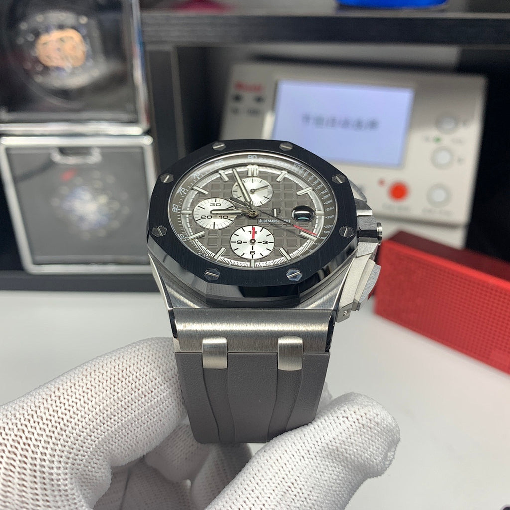 Audemars Piguet chronograph watch with dark dial and three subdials, black bezel