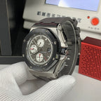Chronograph watch angled view with dark dial and gray strap
