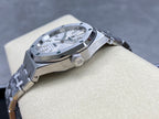 Automatic stainless-steel watch with crown, silver dial, and metal bracelet