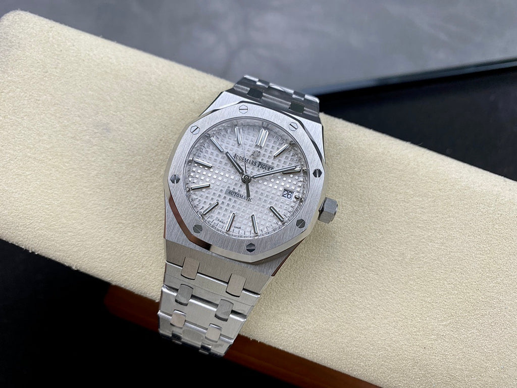 Automatic stainless-steel watch with silver dial, baton indices, and steel bracelet